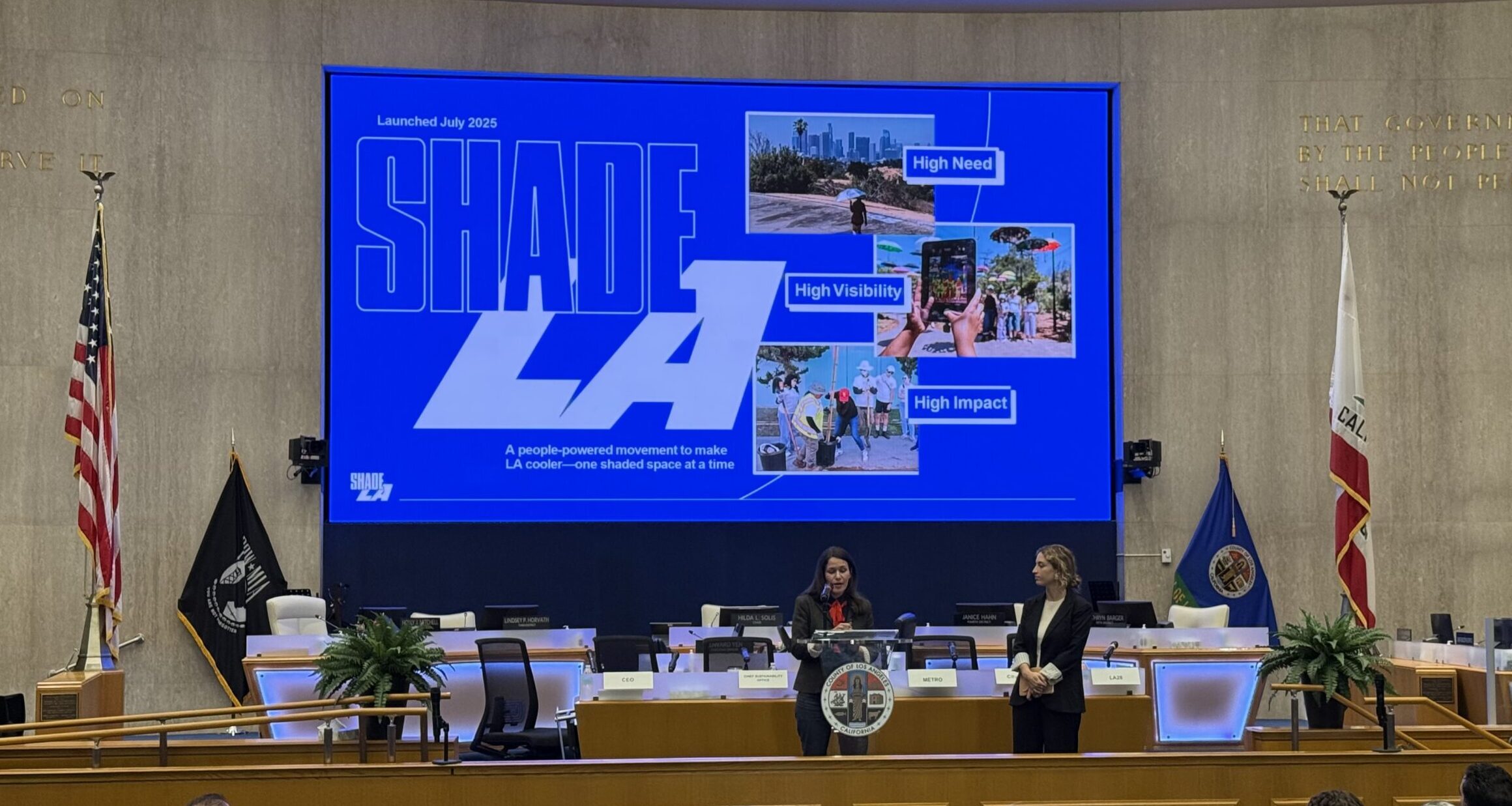 Edith and Marianna presenting in a conference room front of a large screen